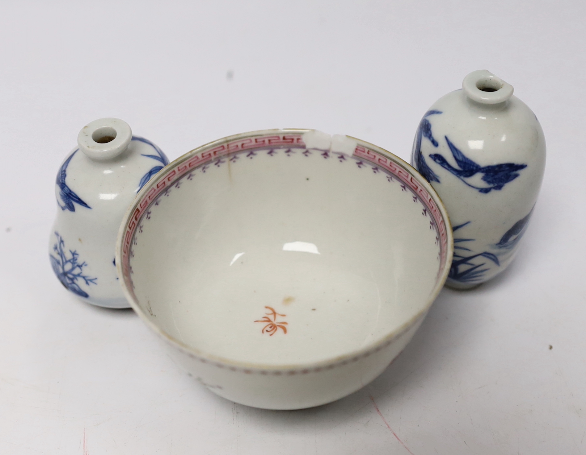 Two Chinese blue and white snuff bottles and a famille rose tea bowl, highest 7cm